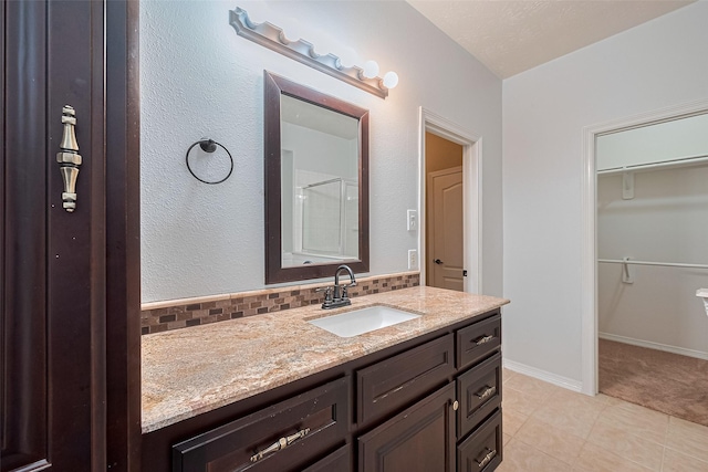 30606 S Sulphur Creek Dr, Magnolia, TX 77355 - full bath featuring vanity, a walk in closet, tile patterned floors, backsplash, and a shower