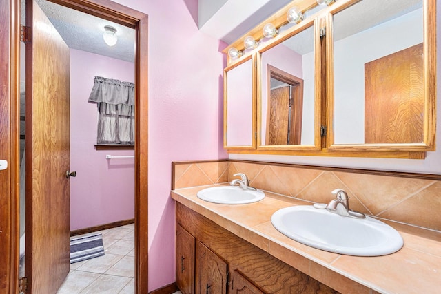 2505 Mary Ave, Pearland, TX 77581 - bathroom with double vanity, backsplash, and tile patterned flooring