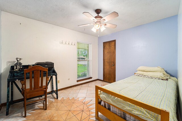 2505 Mary Ave, Pearland, TX 77581 - bedroom with light tile patterned flooring, a textured ceiling, and a ceiling fan