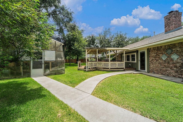 2505 Mary Ave, Pearland, TX 77581 - view of yard with a greenhouse, a wooden deck, and an outbuilding