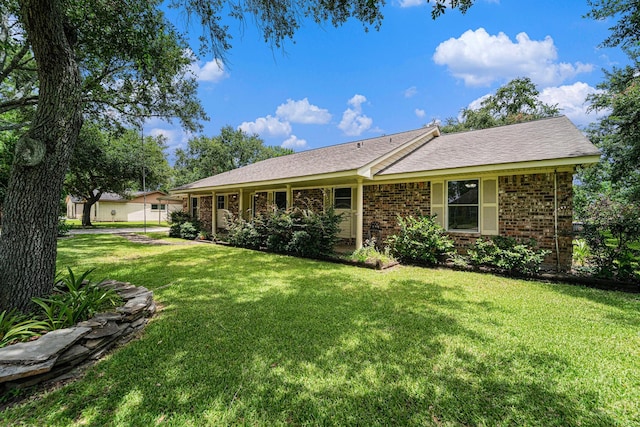 2505 Mary Ave, Pearland, TX 77581 - back of property featuring a lawn, brick siding, and a shingled roof