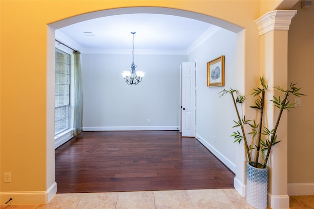 2715 Joshua Tree Ln, Manvel, TX 77578 - unfurnished dining area featuring arched walkways, crown molding, a chandelier, and wood finished floors