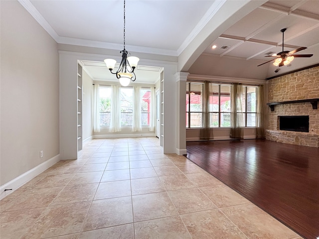 2715 Joshua Tree Ln, Manvel, TX 77578 - unfurnished dining area featuring ceiling fan, healthy amount of natural light, a chandelier, ornamental molding, and a fireplace