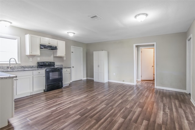 626 W 6th St, Freeport, TX 77541 - kitchen with black electric range, under cabinet range hood, white cabinetry, and dark wood finished floors