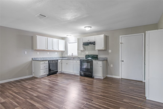 626 W 6th St, Freeport, TX 77541 - kitchen featuring black appliances, under cabinet range hood, white cabinets, and dark wood finished floors