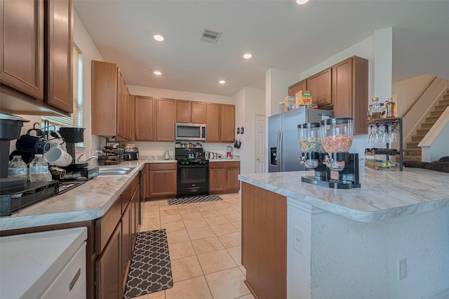 602 Willow Briar Dr, Houston, TX 77090 - kitchen with appliances with stainless steel finishes, light tile patterned flooring, recessed lighting, light countertops, and brown cabinets