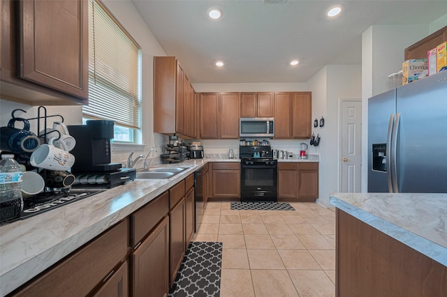 602 Willow Briar Dr, Houston, TX 77090 - kitchen with black appliances, light countertops, light tile patterned floors, recessed lighting, and brown cabinets