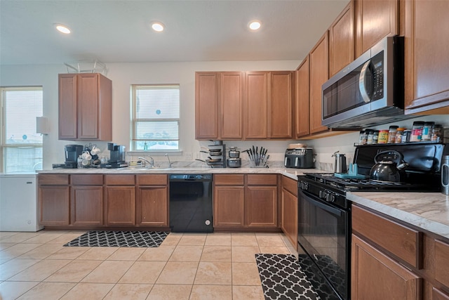 602 Willow Briar Dr, Houston, TX 77090 - kitchen featuring black appliances, light countertops, light tile patterned floors, recessed lighting, and brown cabinetry