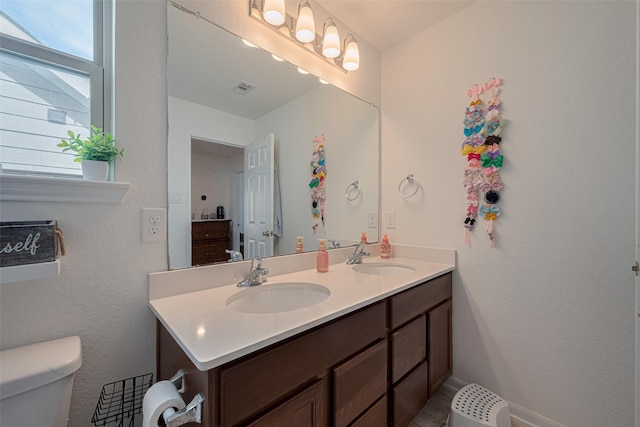 602 Willow Briar Dr, Houston, TX 77090 - bathroom featuring double vanity and toilet