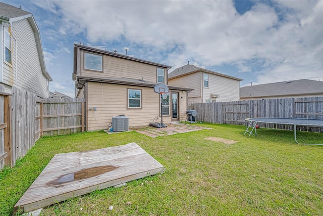 602 Willow Briar Dr, Houston, TX 77090 - back of house featuring a trampoline, a fenced backyard, and a wooden deck