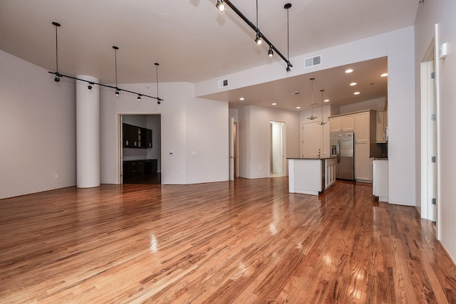 5005 Hidalgo St Unit 210, Houston, TX 77056 - unfurnished living room with light wood finished floors and recessed lighting