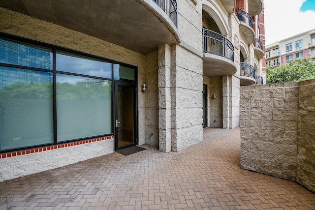 5005 Hidalgo St Unit 210, Houston, TX 77056 - property entrance with stone siding, a balcony, and brick siding