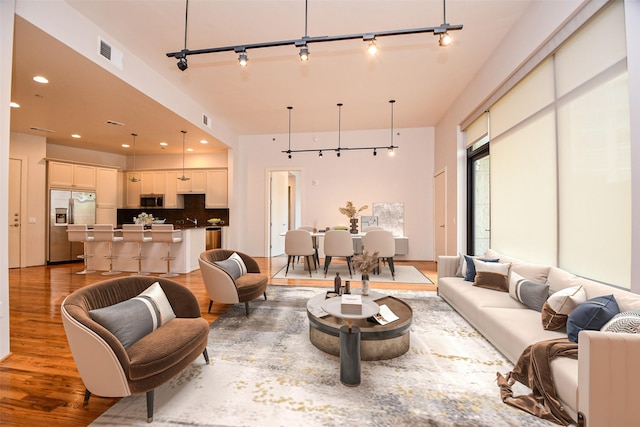 5005 Hidalgo St Unit 210, Houston, TX 77056 - living area with rail lighting, light wood-type flooring, and recessed lighting