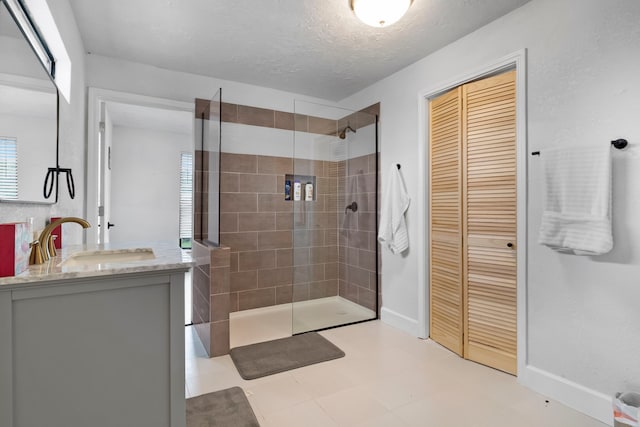110 Lakeview Shores Dr, Coldspring, TX 77331 - bathroom with a walk in shower, vanity, a closet, and a textured ceiling
