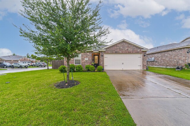 21118 Baltic Rain Dr, Hockley, TX 77447 - view of front facade with brick siding, an attached garage, driveway, and a front yard
