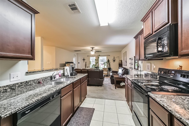 21118 Baltic Rain Dr, Hockley, TX 77447 - kitchen featuring black appliances, light colored carpet, light tile patterned floors, open floor plan, and ceiling fan