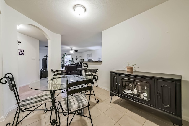 21118 Baltic Rain Dr, Hockley, TX 77447 - dining space featuring arched walkways, a ceiling fan, and light tile patterned flooring