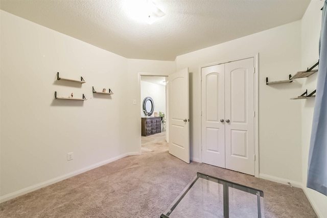 21118 Baltic Rain Dr, Hockley, TX 77447 - unfurnished bedroom with carpet, a closet, and a textured ceiling