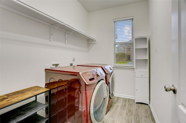 3905 Chartham Ln, Pearland, TX 77584 - laundry room featuring separate washer and dryer and light wood finished floors