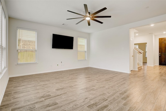 3905 Chartham Ln, Pearland, TX 77584 - unfurnished living room featuring light wood-type flooring, ceiling fan, stairs, and recessed lighting