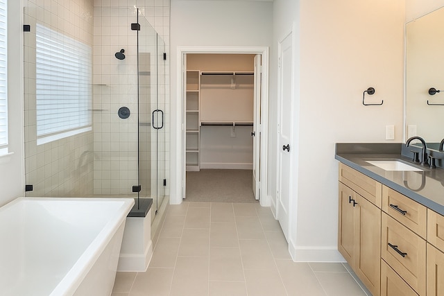 2519 S Houston Ave, Pearland, TX 77581 - full bath with a shower stall, a walk in closet, a freestanding bath, vanity, and tile patterned flooring