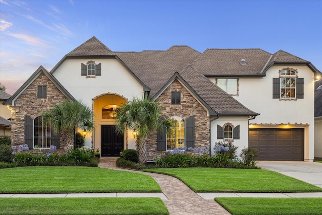 5214 Bristol Bank Ct, Houston, TX 77041 - french country style house featuring stone siding, stucco siding, concrete driveway, an attached garage, and a front yard
