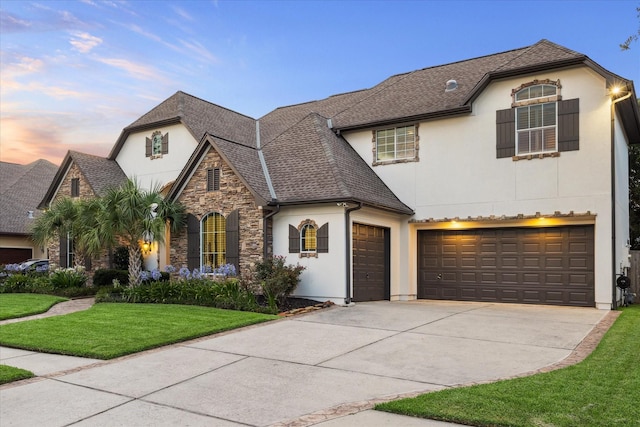 5214 Bristol Bank Ct, Houston, TX 77041 - french provincial home featuring stucco siding, concrete driveway, stone siding, a lawn, and an attached garage