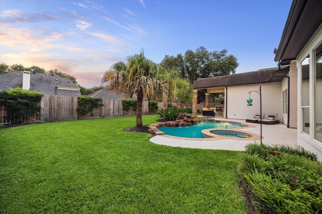 5214 Bristol Bank Ct, Houston, TX 77041 - yard at dusk with an in-ground hot tub, a patio area, and a fenced backyard