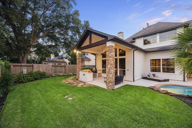 5214 Bristol Bank Ct, Houston, TX 77041 - back of property featuring exterior kitchen, a patio, a fenced backyard, stucco siding, and a chimney