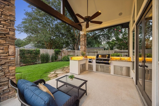5214 Bristol Bank Ct, Houston, TX 77041 - fenced backyard with an outdoor kitchen, a ceiling fan, and a patio area