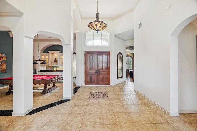 5214 Bristol Bank Ct, Houston, TX 77041 - foyer entrance with billiards, a high ceiling, ornamental molding, and tile patterned flooring