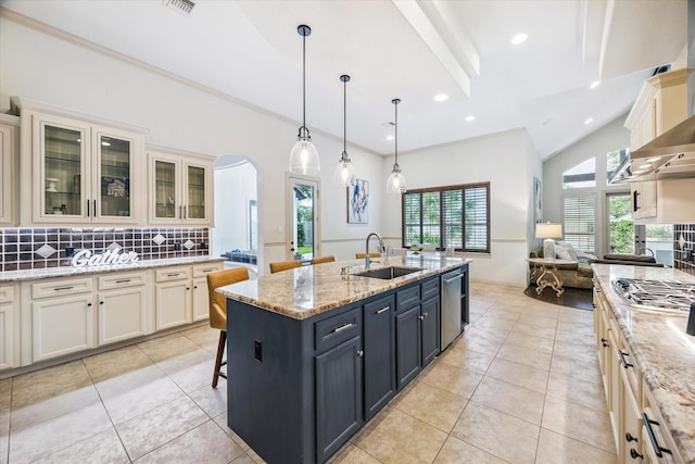 5214 Bristol Bank Ct, Houston, TX 77041 - kitchen featuring arched walkways, appliances with stainless steel finishes, decorative backsplash, light tile patterned floors, and recessed lighting