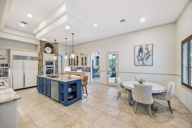 5214 Bristol Bank Ct, Houston, TX 77041 - kitchen with built in appliances, open shelves, blue cabinets, backsplash, and a center island with sink