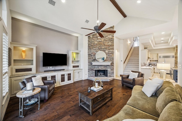 5214 Bristol Bank Ct, Houston, TX 77041 - living room with a ceiling fan, high vaulted ceiling, beam ceiling, dark wood-type flooring, and a stone fireplace
