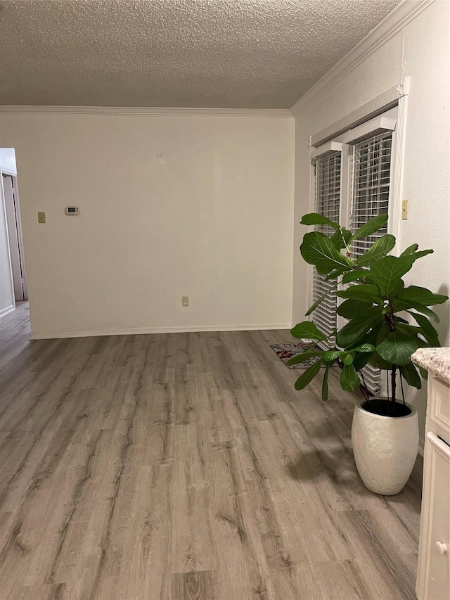6101 Maywood Dr, Houston, TX 77053 - spare room featuring ornamental molding, wood finished floors, and a textured ceiling