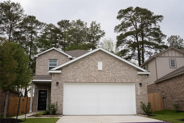 64 Valiant Ridge Trl, Magnolia, TX 77354 - view of front of house with concrete driveway, an attached garage, and stone siding