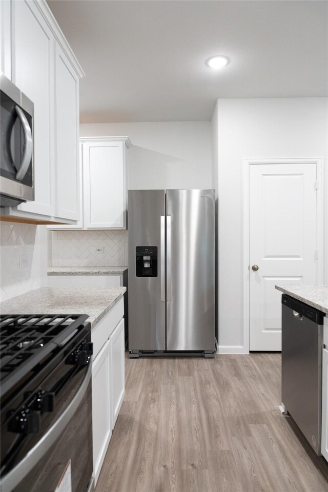 64 Valiant Ridge Trl, Magnolia, TX 77354 - kitchen featuring stainless steel appliances, light wood-type flooring, white cabinets, and recessed lighting