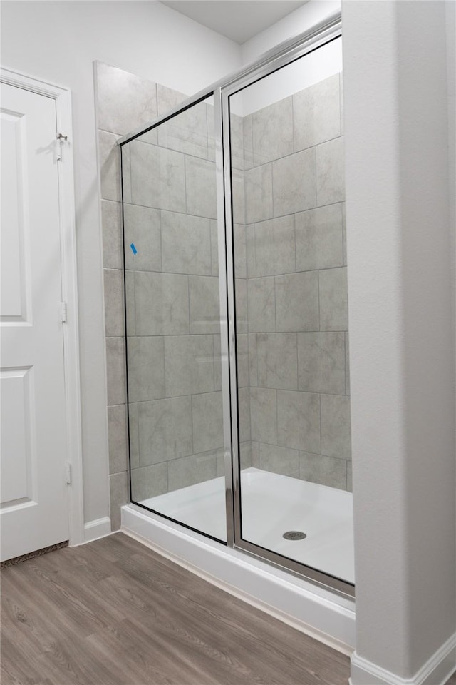 64 Valiant Ridge Trl, Magnolia, TX 77354 - bathroom with a shower stall and wood finished floors