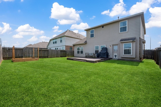7910 Brooks Crossing Dr, Baytown, TX 77521 - rear view of house featuring a fenced backyard, a wooden deck, and a garden