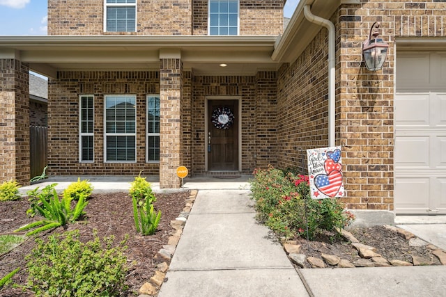 7910 Brooks Crossing Dr, Baytown, TX 77521 - view of exterior entry featuring brick siding and a garage