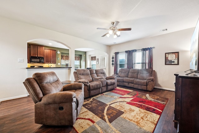 7910 Brooks Crossing Dr, Baytown, TX 77521 - living area featuring arched walkways, dark wood-style floors, and ceiling fan