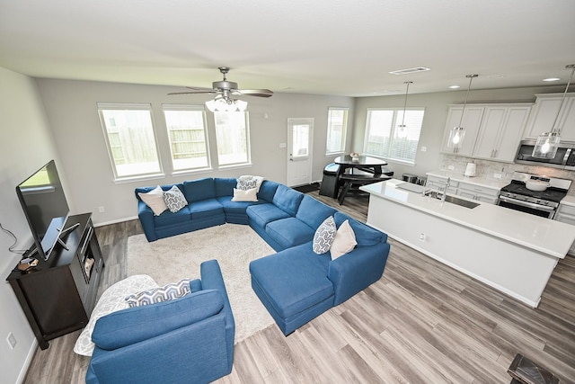 25915 Native Sapphire Ct, Richmond, TX 77406 - living room featuring wood finished floors, a ceiling fan, and recessed lighting