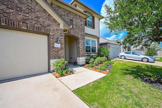25915 Native Sapphire Ct, Richmond, TX 77406 - view of front facade with brick siding, a front yard, concrete driveway, and a garage