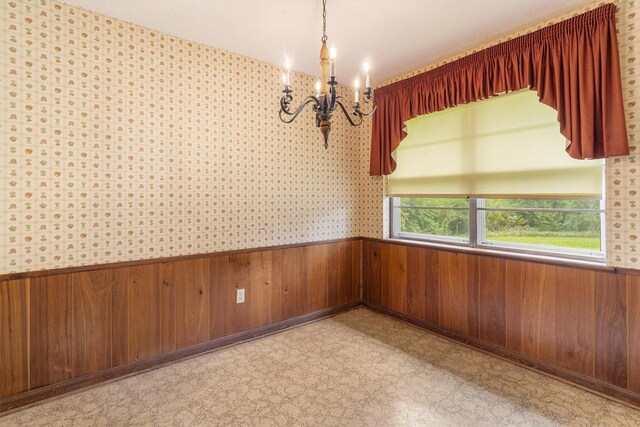 2718 Stratford St, Pearland, TX 77581 - empty room with a wainscoted wall, a chandelier, light flooring, and wooden walls
