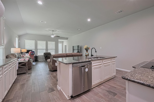 9198 Sierra Del Carmen, Conroe, TX 77303 - kitchen with stainless steel dishwasher, a ceiling fan, dark stone countertops, vaulted ceiling, and wood finished floors