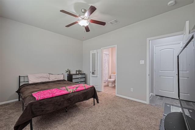 9198 Sierra Del Carmen, Conroe, TX 77303 - bedroom featuring light colored carpet, ensuite bath, and a ceiling fan