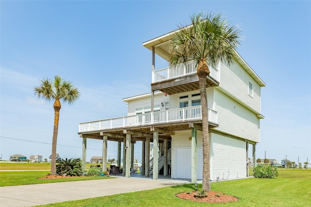 18614 Warrior Rd, Galveston, TX 77554 - view of front of home featuring a balcony, an attached garage, a front yard, driveway, and stairs