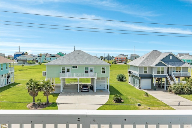 18614 Warrior Rd, Galveston, TX 77554 - rear view of house featuring driveway, a residential view, and stairs