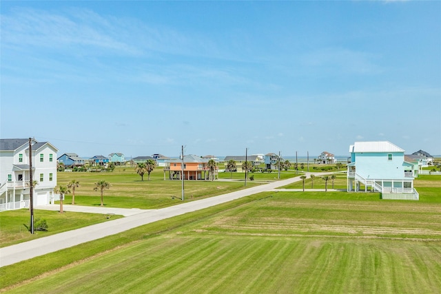 18614 Warrior Rd, Galveston, TX 77554 - surrounding community featuring a garage, concrete driveway, a yard, and a residential view