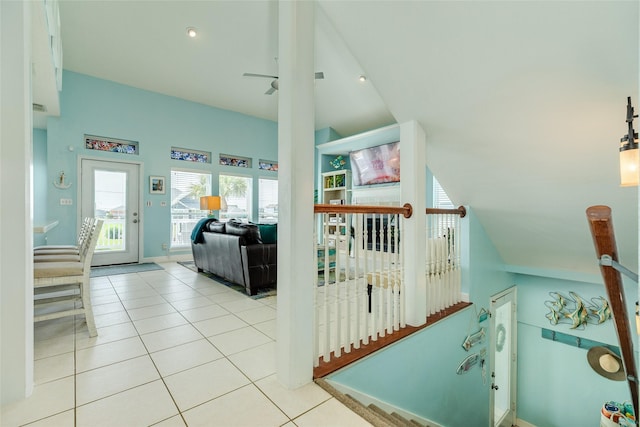 18614 Warrior Rd, Galveston, TX 77554 - stairs with tile patterned flooring, ceiling fan, and vaulted ceiling